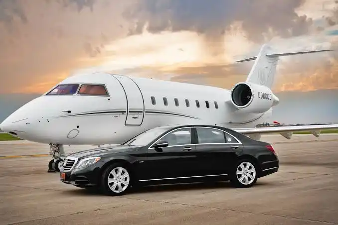 Black Sedan Beside Private Jet