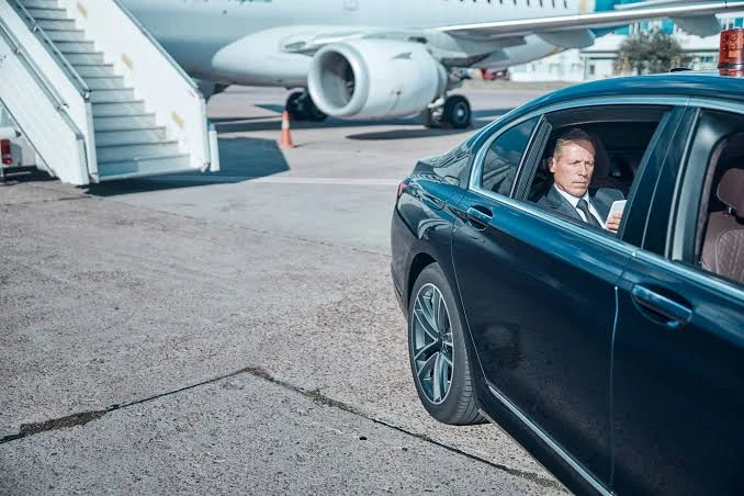 Luxury Car Beside Airport Plane