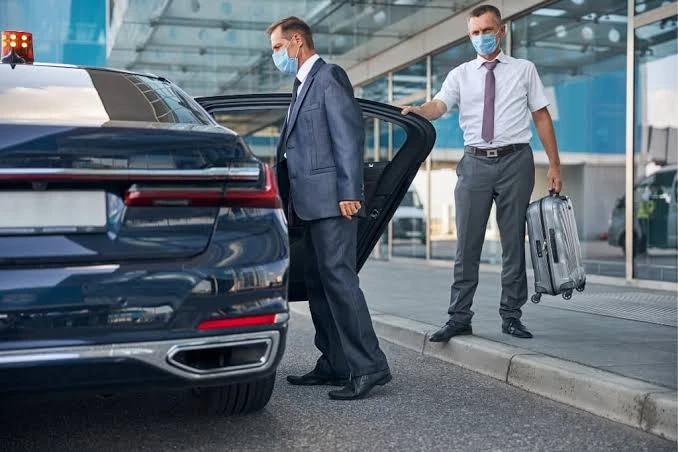 Chauffeur Assisting Airport Car Passenger