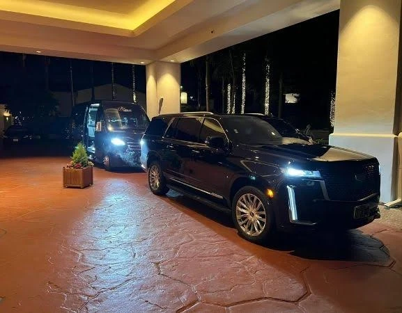 Black SUV and shuttle van